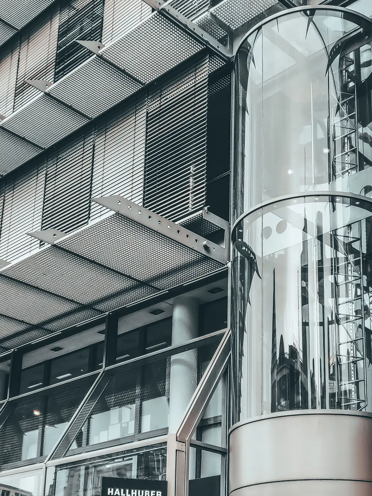 Sample image: panoramic glass capsule lift on the exterior of a modern building