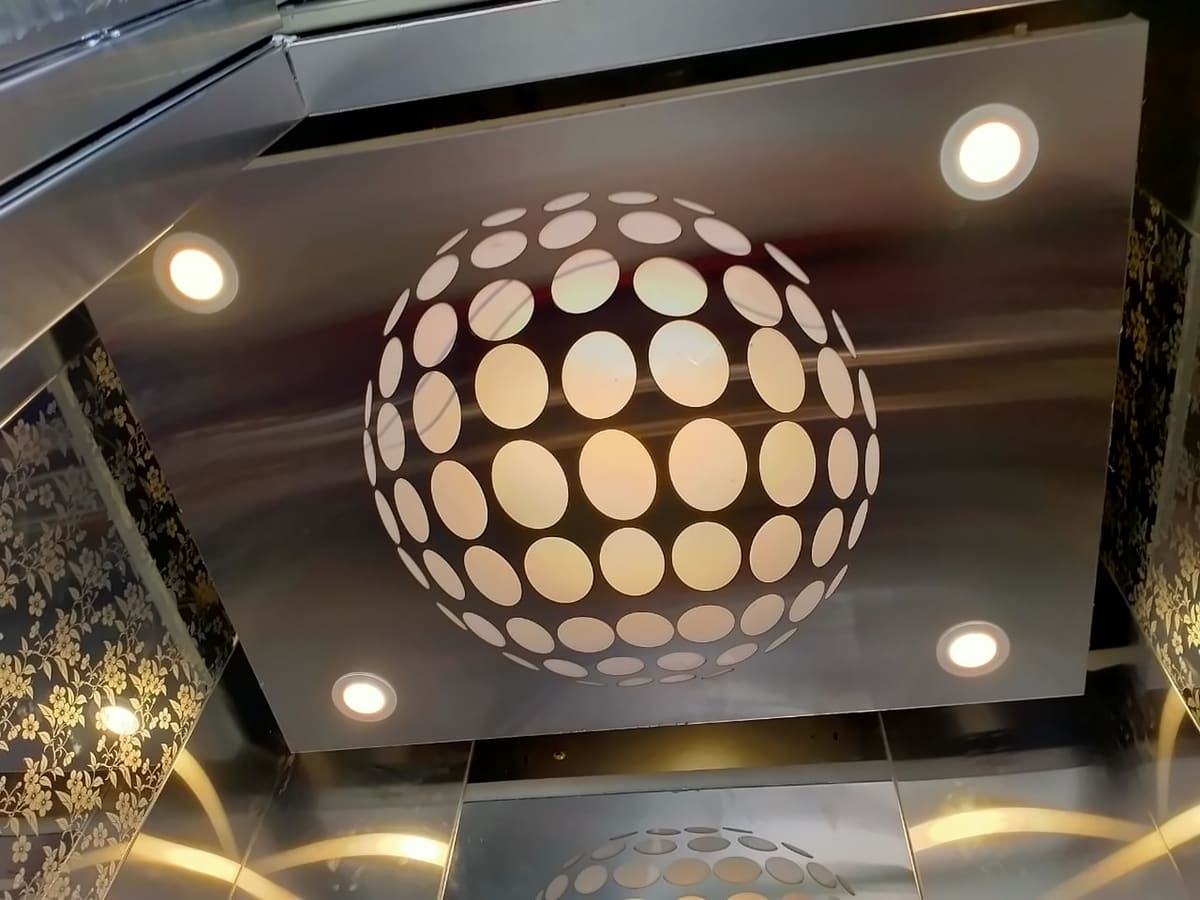 Sakshi lift cabin ceiling with a spherical light feature