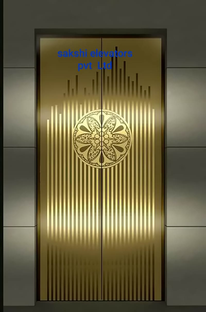 Gold designer lift landing doors with a vertical line pattern and central medallion