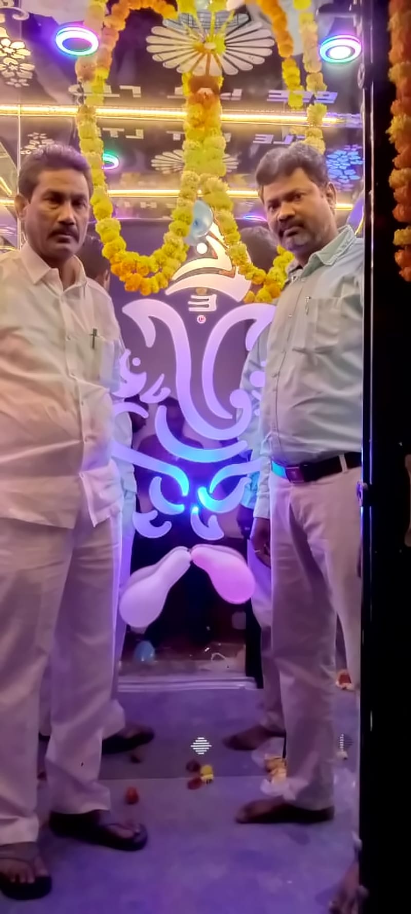 Sakshi Elevators owner with a customer inside a newly installed lift cabin decorated with a flower garland